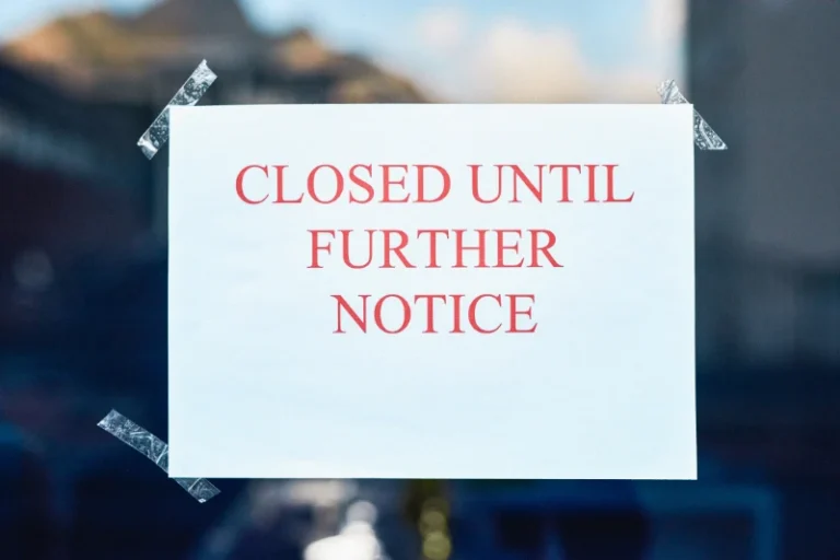 Sign taped to a glass door reading 'CLOSED UNTIL FURTHER NOTICE' in red letters